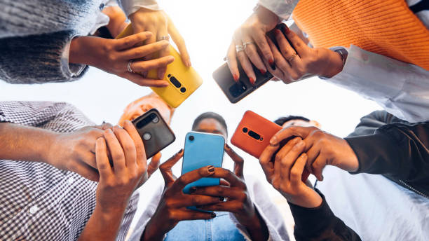 multiple people with phones in a circle