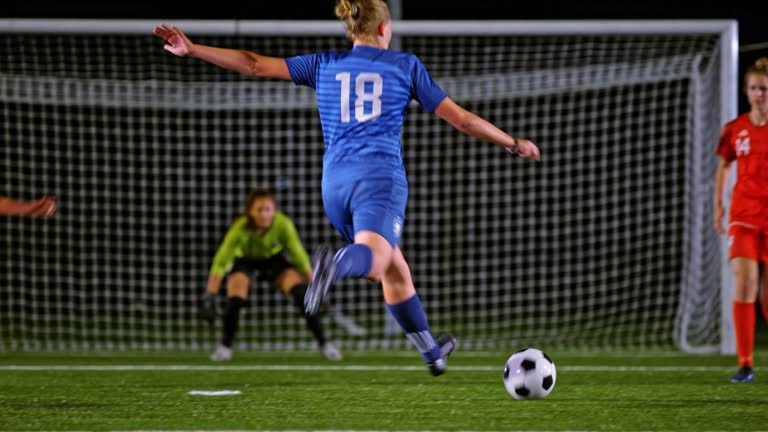 Soccer player kicking a goal